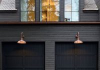 The Black Painted House with Horizontal Wood Piece Over Garage Doors: A Unique Architectural Style